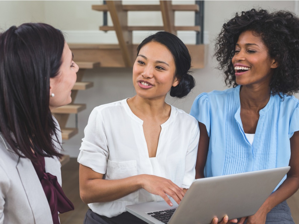 female-business-colleagues-discussing-on-laptop-picture-id663803382